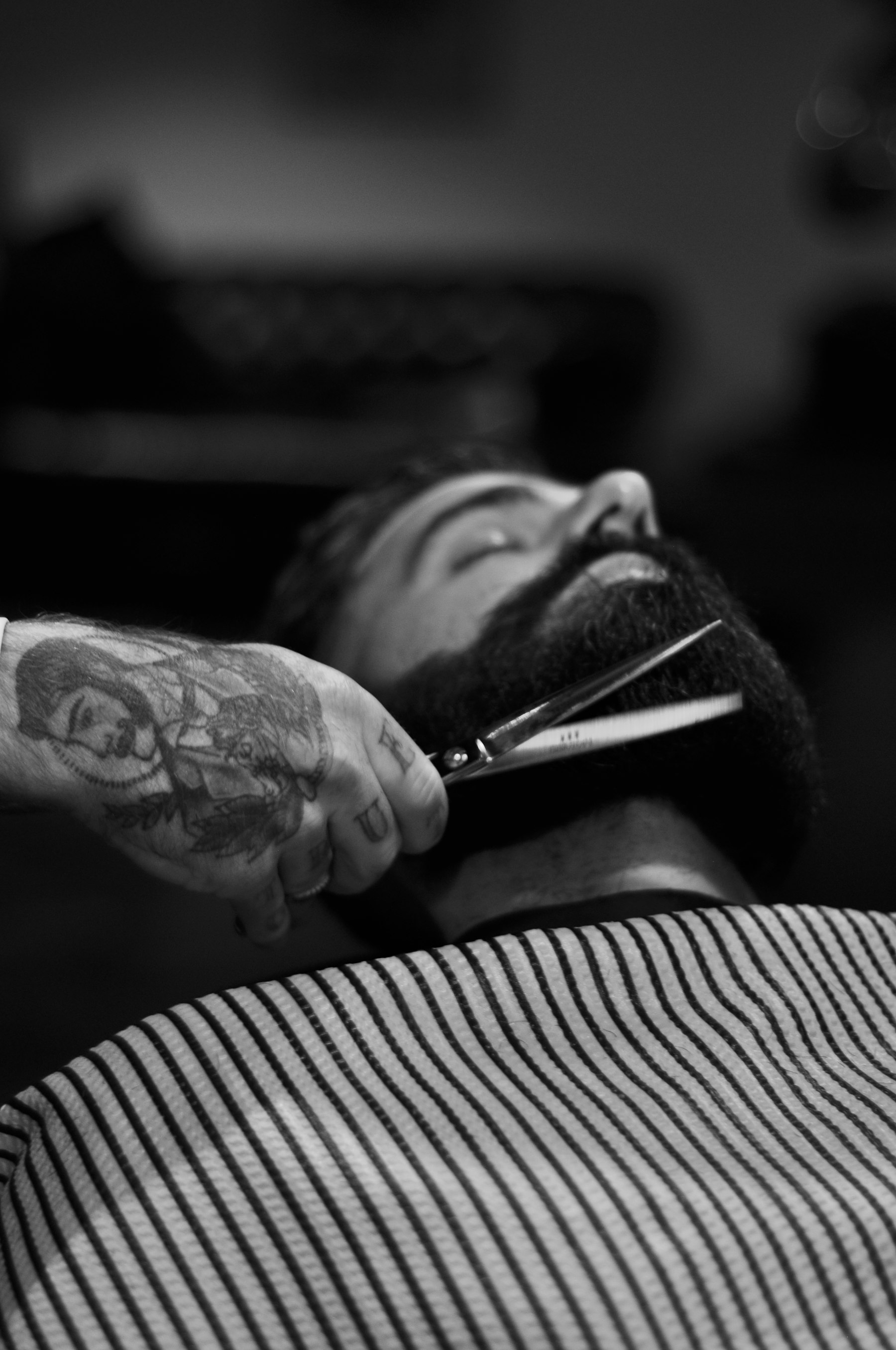 Black and white close-up of a straight razor beard line-up — reference photo
