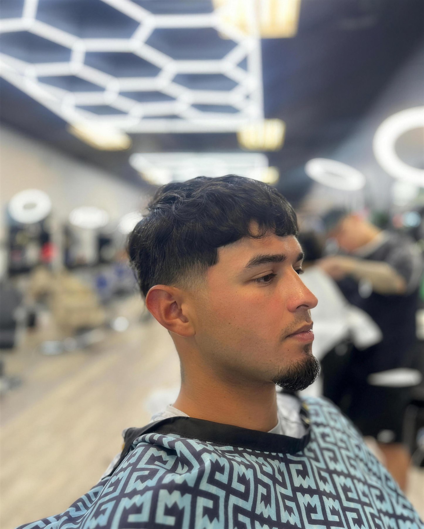 Real T-Low client with a finished taper fade, shot inside the shop