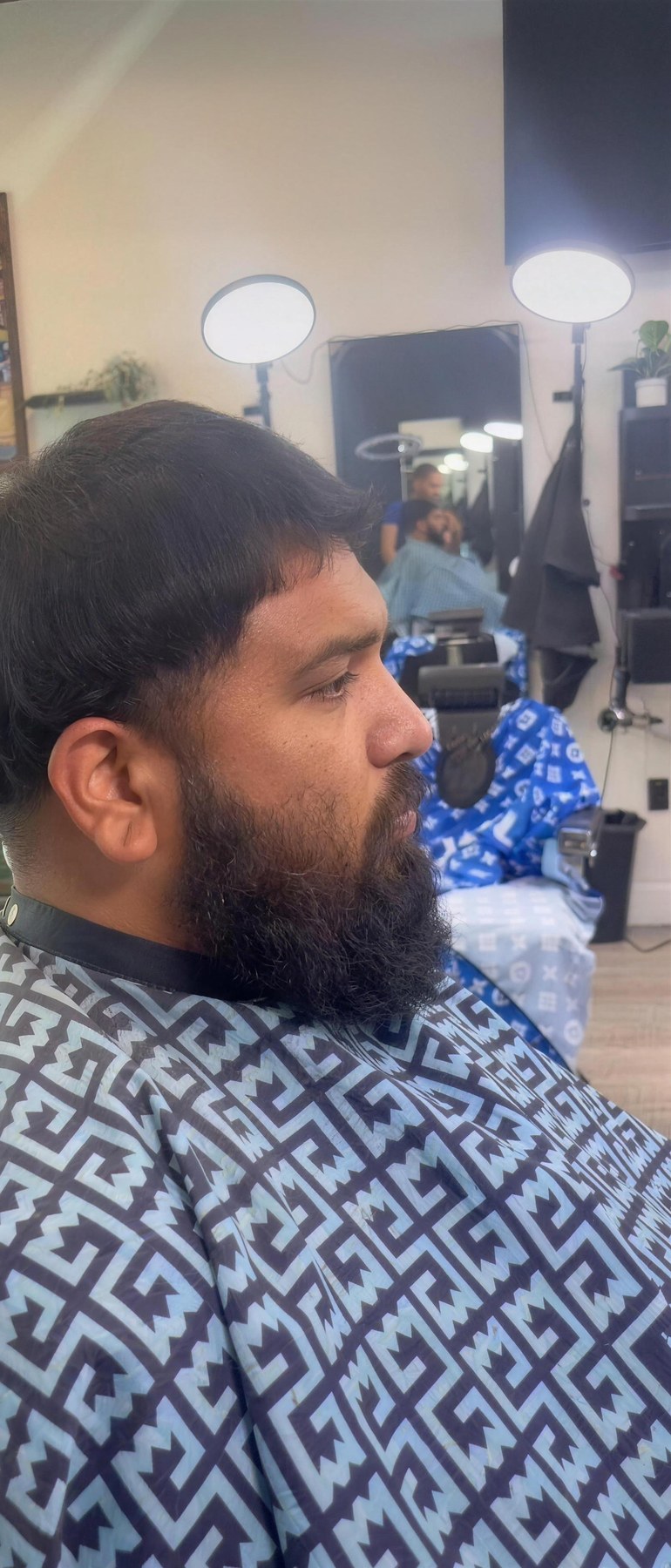 Real T-Low client with a full beard and clean fade, inside the real shop