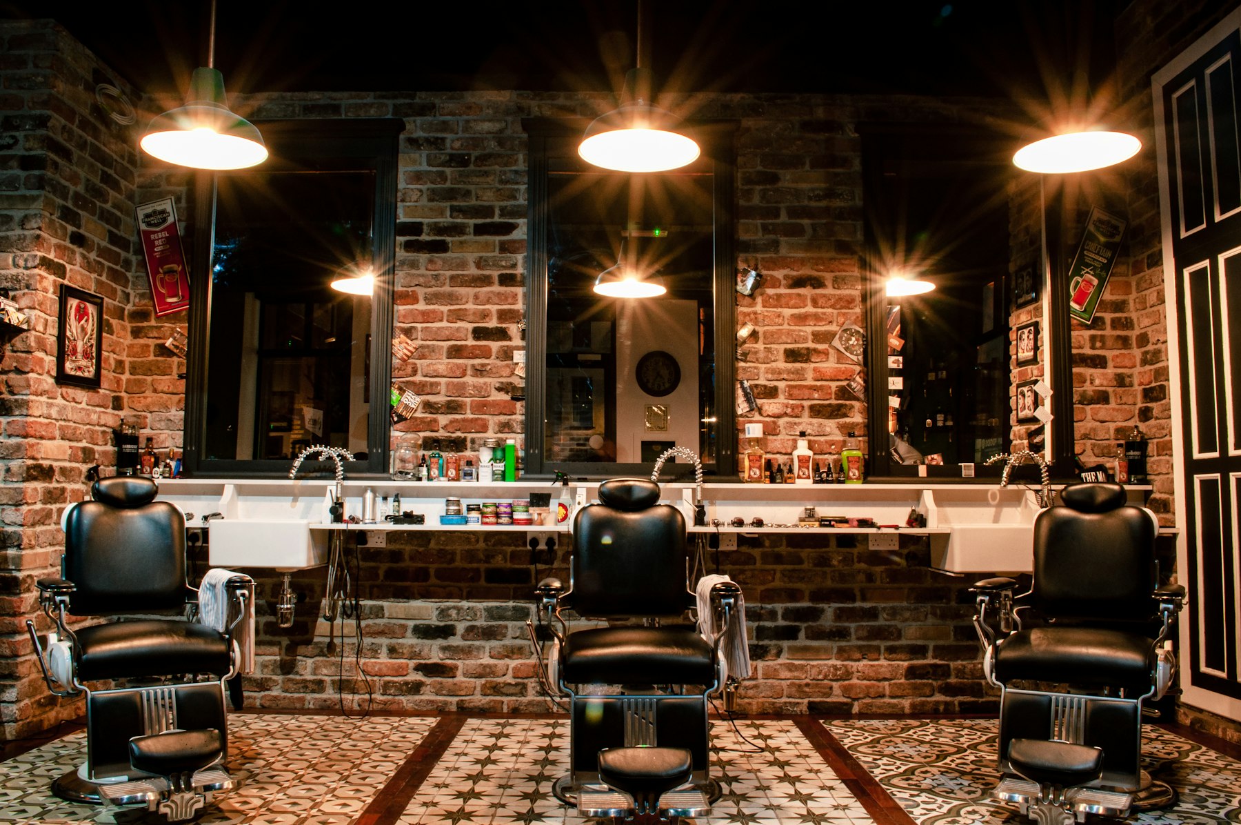 Barbershop chairs and mirrors along a brick wall — reference photo