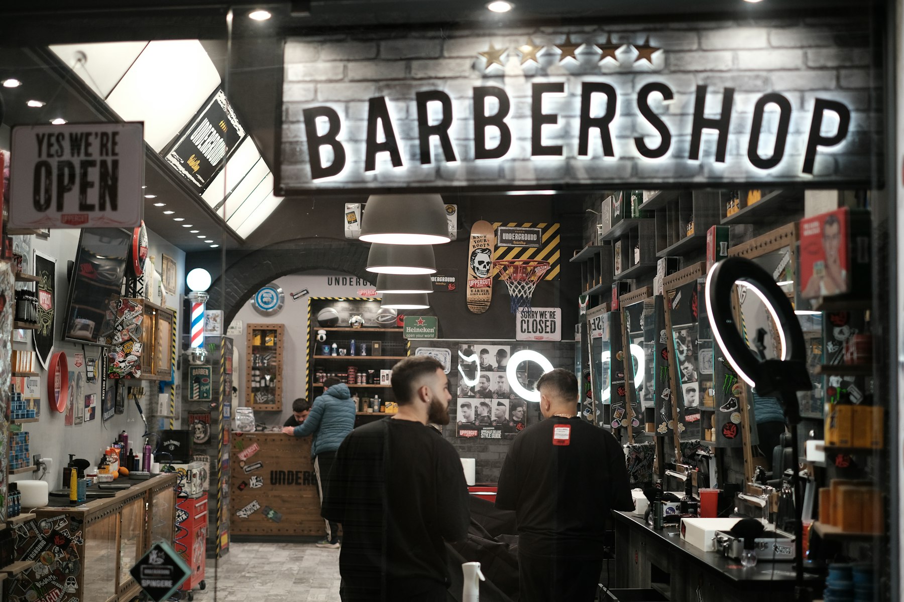 Neon BARBERSHOP storefront sign at night — reference photo
